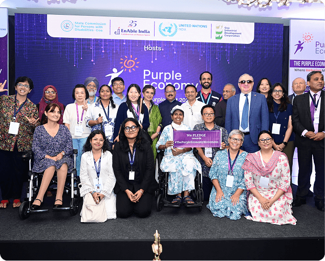 Group of participants posing together at a Purple Economy disability inclusion event.
