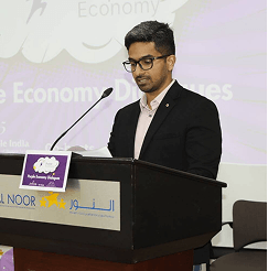 Neeraj krishnan speaking at a podium during a conference presentation.