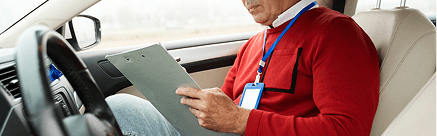 Driver reviewing a checklist inside a car during driver sensitization training.