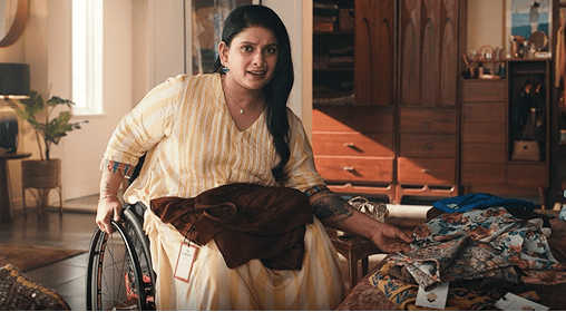 Woman using a wheelchair sorting clothes at home.